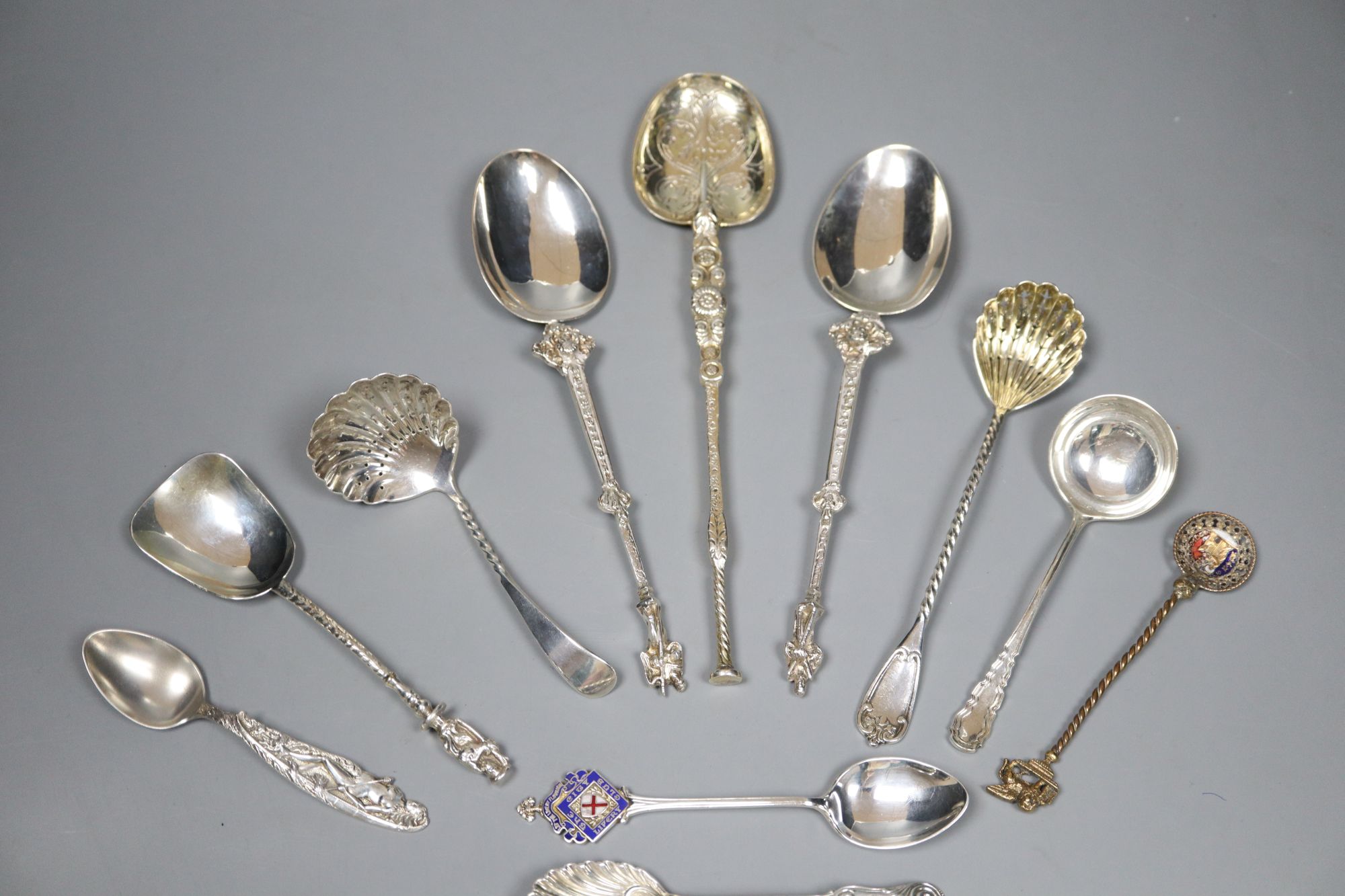 An ornate Edwardian silver gilt spoon, 22cm, ten other assorted silver spoons including continental and silver and two small